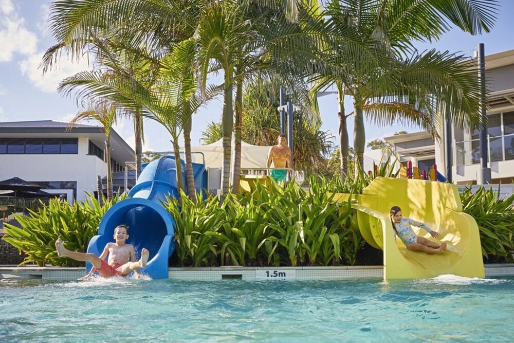 Two kids on a waterslide