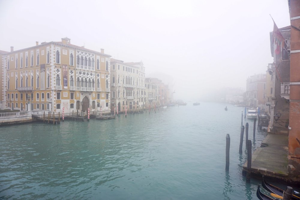 Venice canal covered in mist during winter flooding season