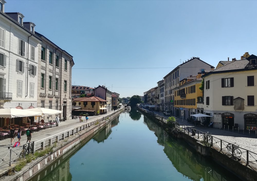 Navigli canals in Milan lined with restaurants and cafés on a sunny day