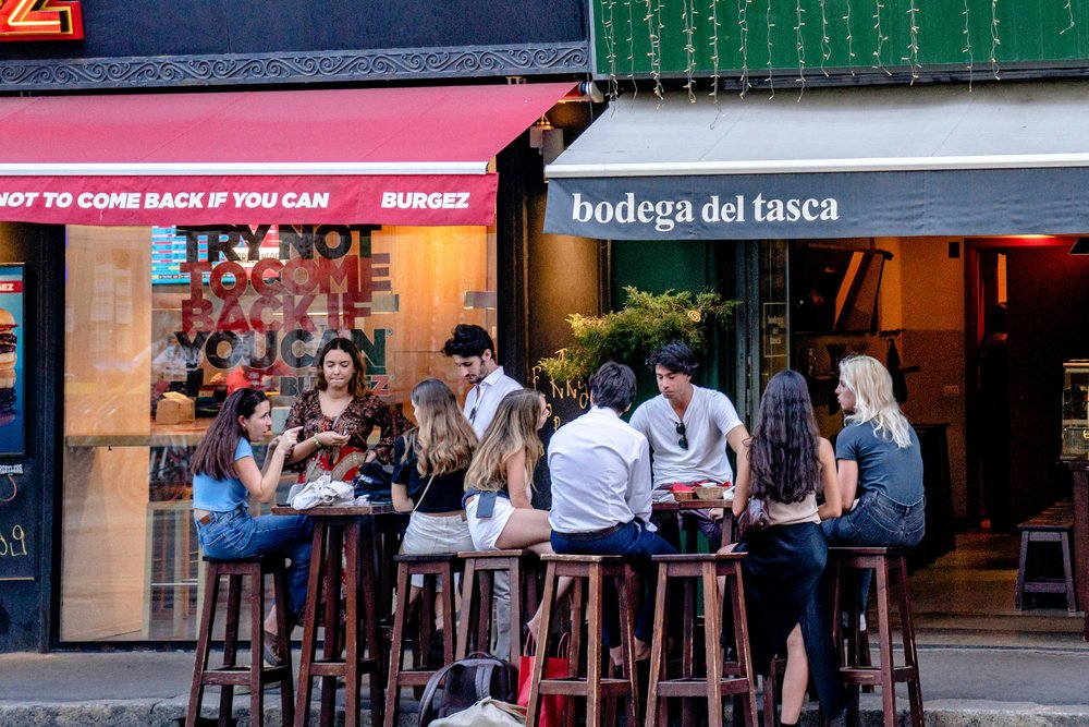 Guide explaining chocolate-making to visitors inside a Milan chocolate workshop