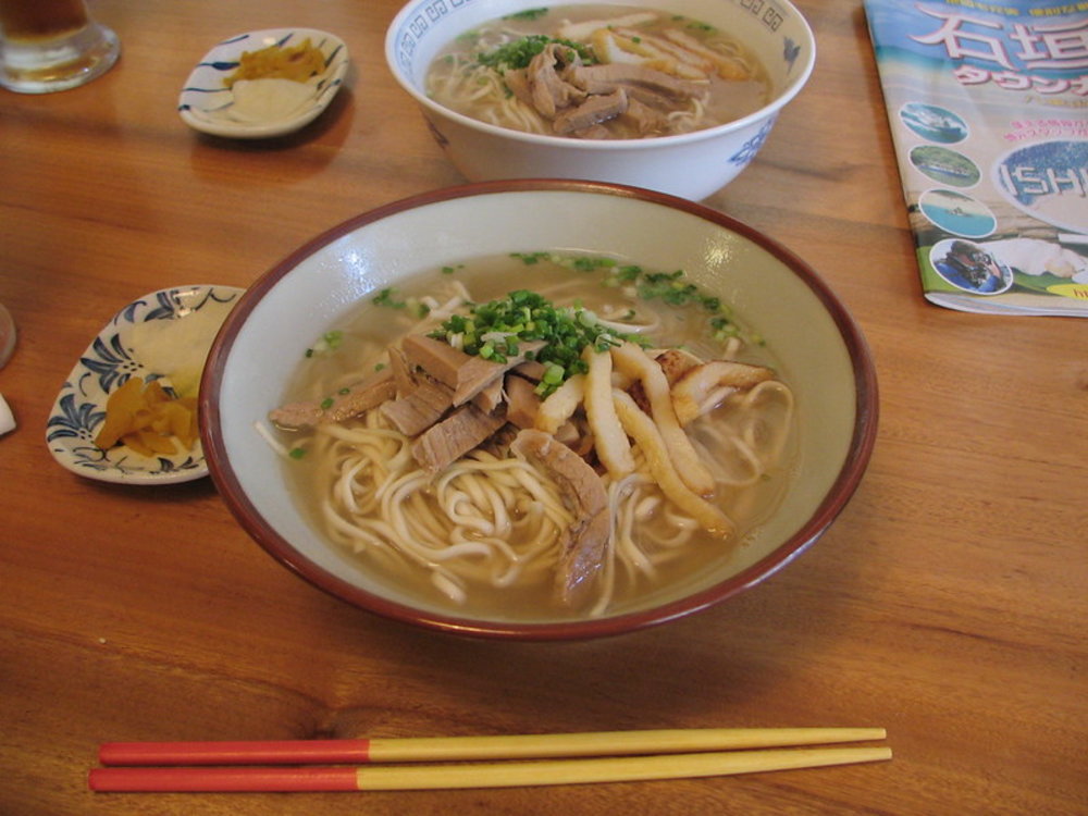 Okinawa soba noodles topped with pork and green onions in clear broth