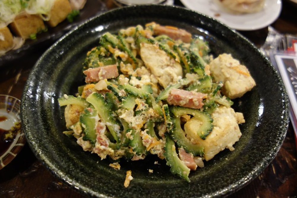 Okinawan goya champuru with bitter melon, tofu, egg, and pork on a plate