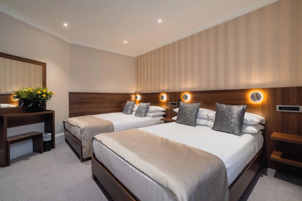Twin-bed hotel room in London perfect for families or group travelers
