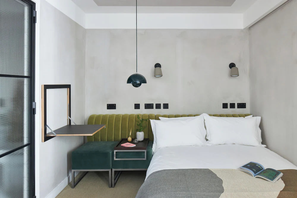 Affordable hotel room in London with minimalist design and cozy seating