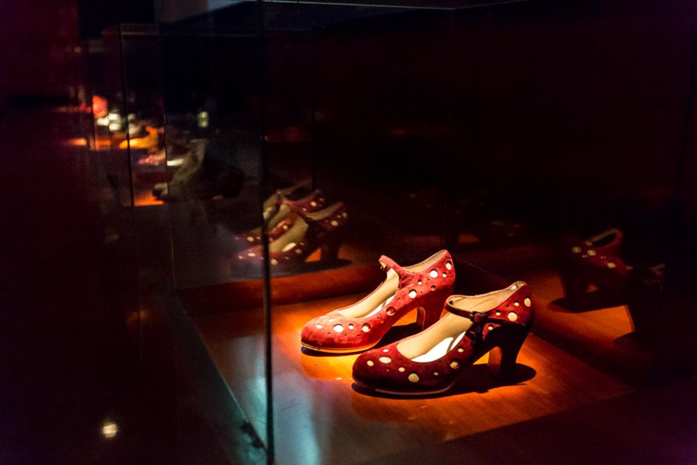 Red flamenco dance shoes displayed inside the Flamenco Dance Museum in Seville