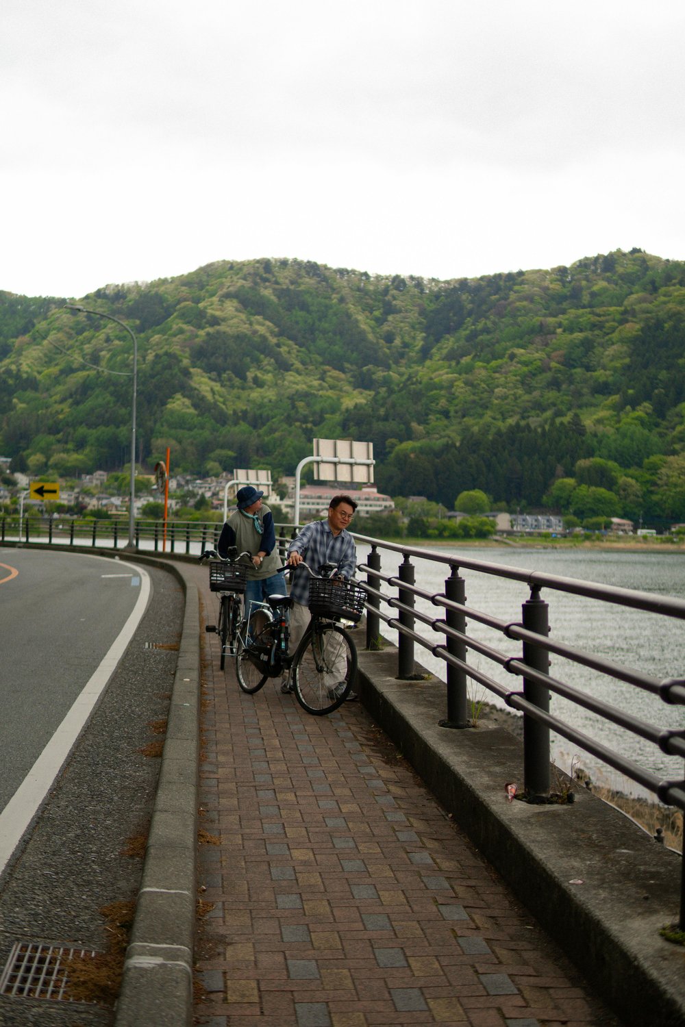  Travelers biking along a riverside path in Japan | Talha Resitoglu on Pexels