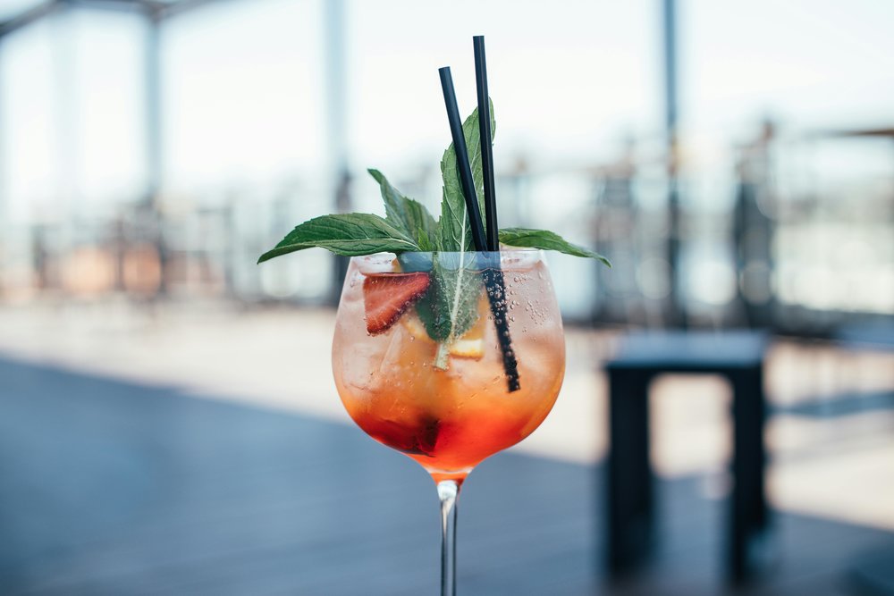 Cocktail with fruit garnish at a rooftop bar in Auckland