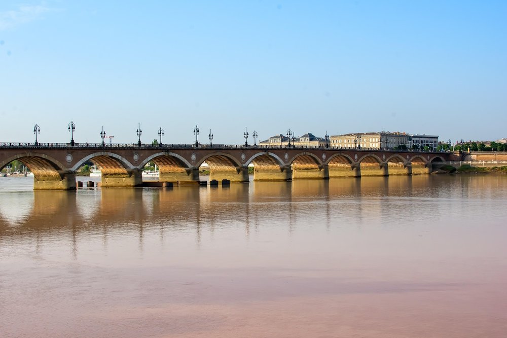 Garonne River with historic bridge in Bordeaux