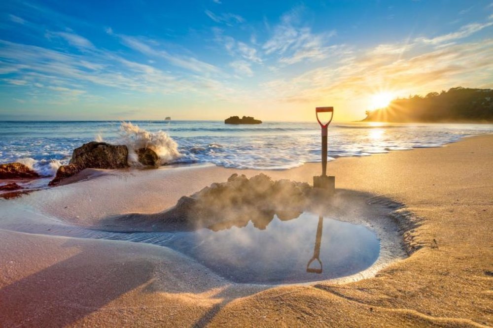 Natural hot pool dug in the sand at Hot Water Beach