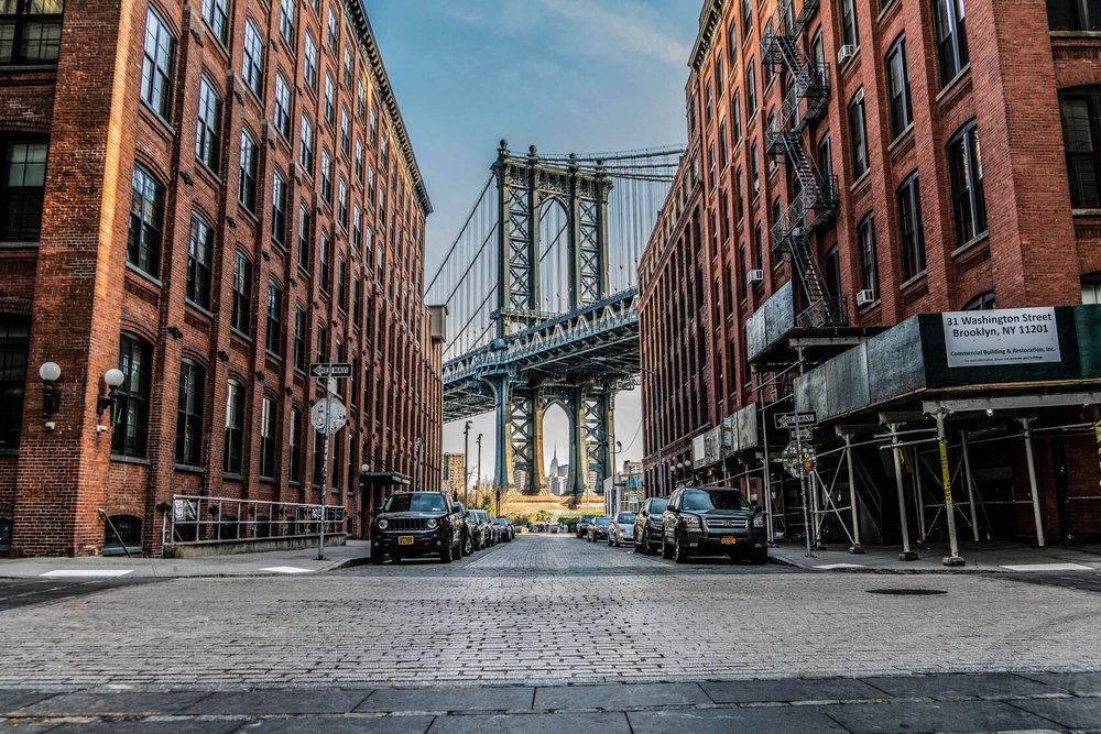 DUMBO Brooklyn street view with Manhattan Bridge and historic brick buildings