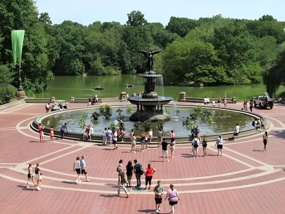 Central Park Bethesda Fountain surrounded by trees and people enjoying the park
