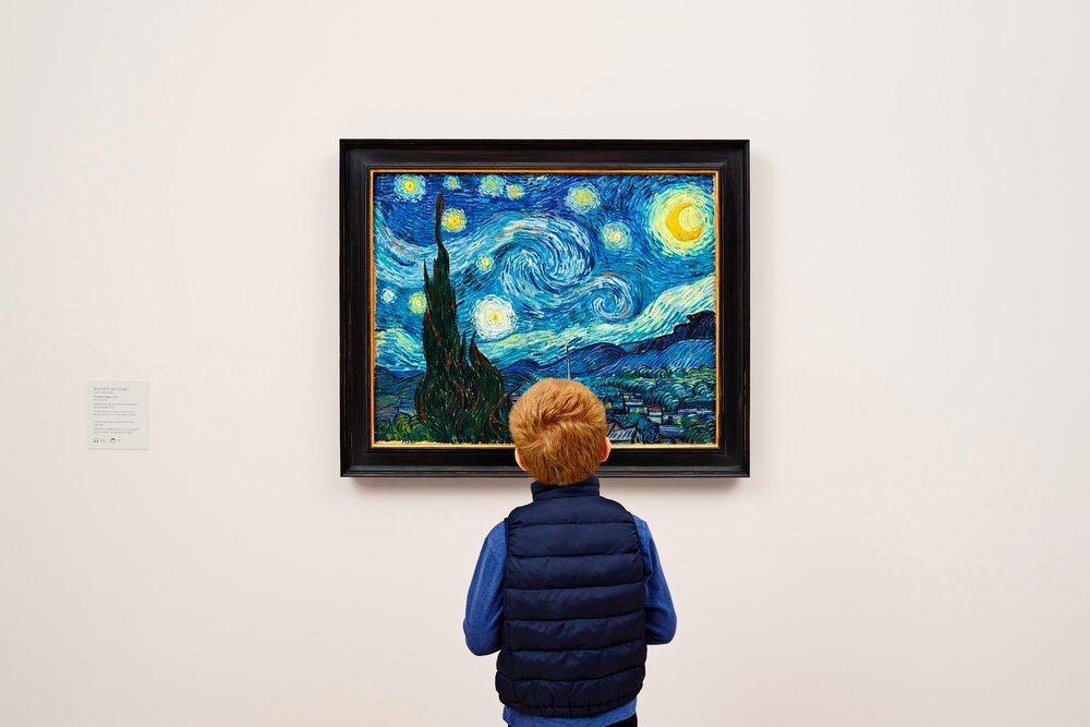 Person looking at Van Gogh’s Starry Night painting inside MoMA in New York City