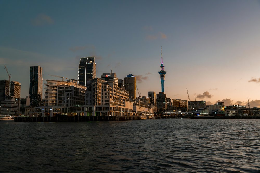 Auckland CBD skyline at sunset with Sky Tower overlooking the waterfront