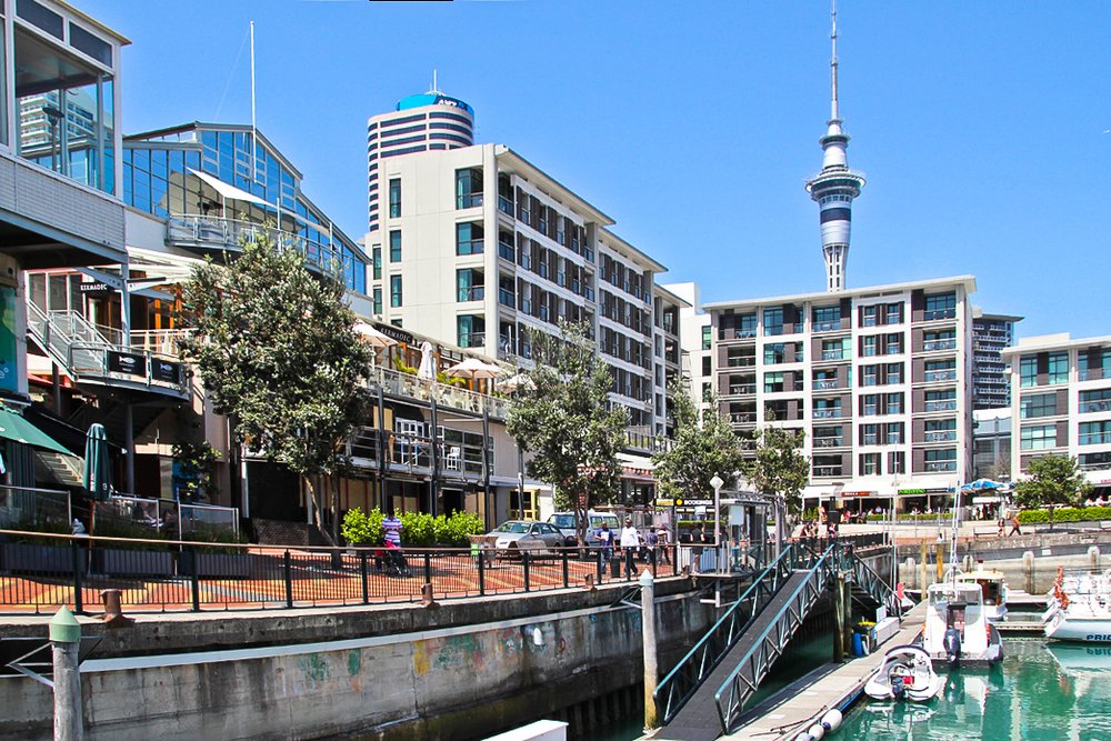 Viaduct Harbour waterfront in Auckland with marina, cafes, and city skyline