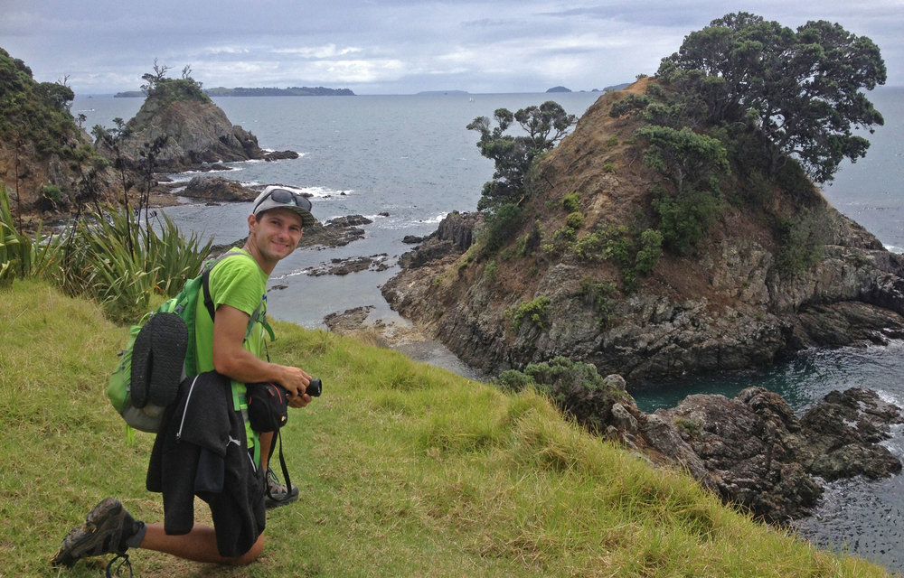 Traveler overlooking rocky coastline and ocean views on Waiheke Island near Auckland