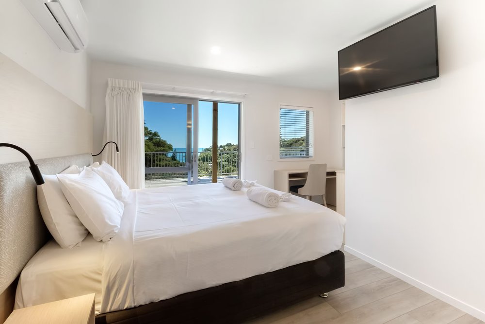 Waiheke Island Resort room featuring balcony views, natural light, and modern coastal design