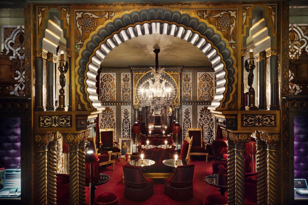Opulent interior of Maison Souquet Hotel featuring rich colors, arches, and historic Parisian design