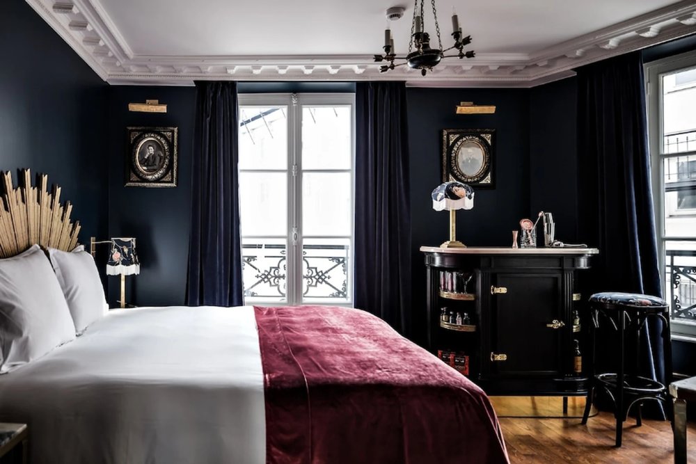 Dark-toned boutique hotel room at Hotel Providence Paris with artistic decor and city views