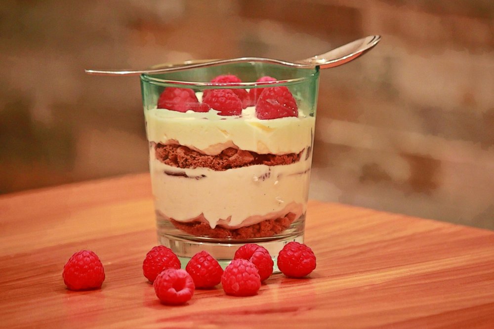 Traditional British trifle with custard and raspberries