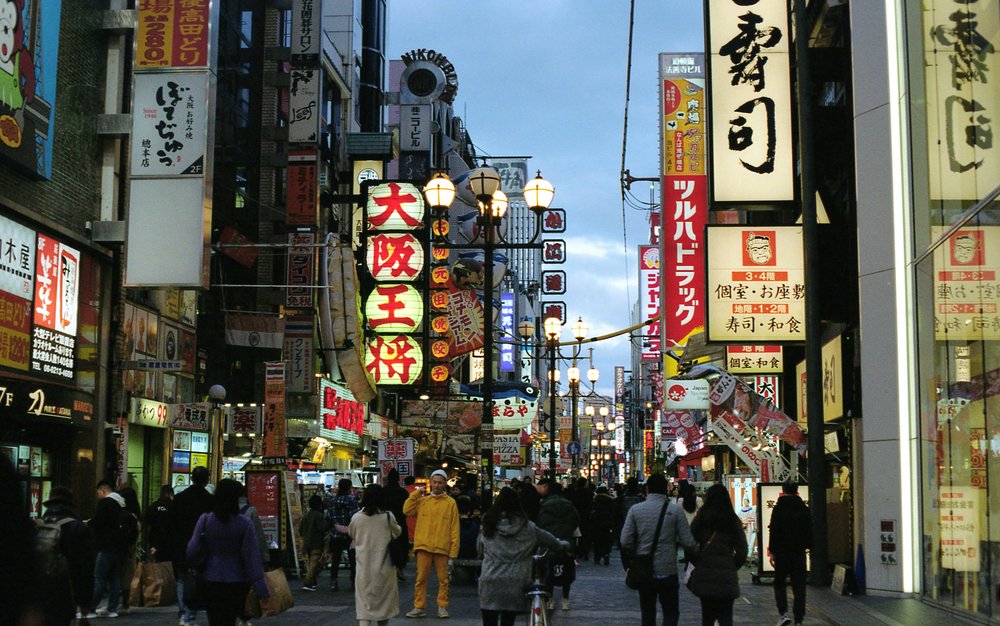 Busy Osaka street with neon signs at night