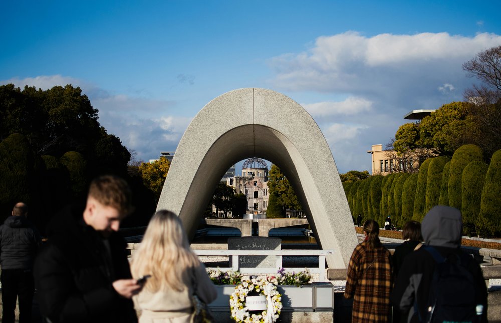 Hiroshima Peace Memorial with people visiting, symbol of peace and resilience