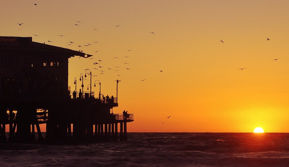 Sunset skies over Santa Monica Pier, LA | Photo Credits: Zi Xian Leong on Wikimedia