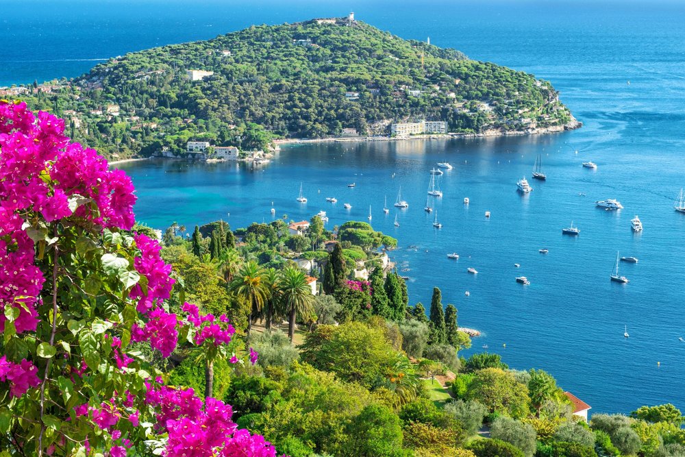 French Riviera coastline with clear blue water and boats