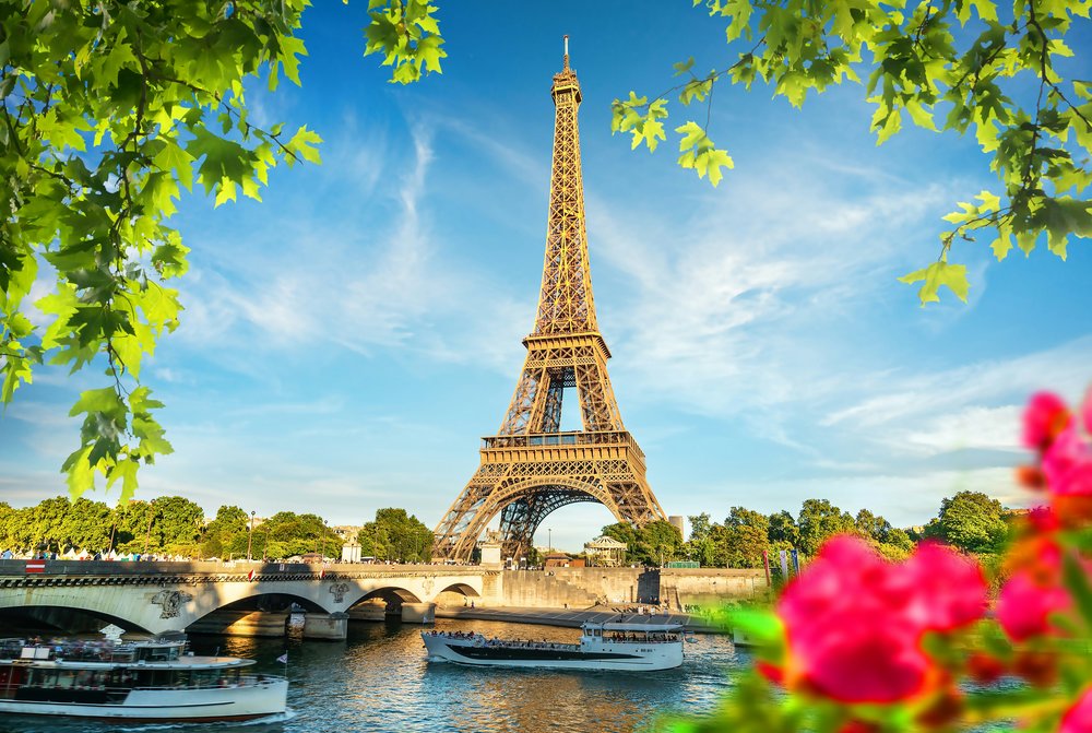 Eiffel Tower in Paris with the Seine River on a sunny day | Photo Credit: Ali Rizvi on Unsplash