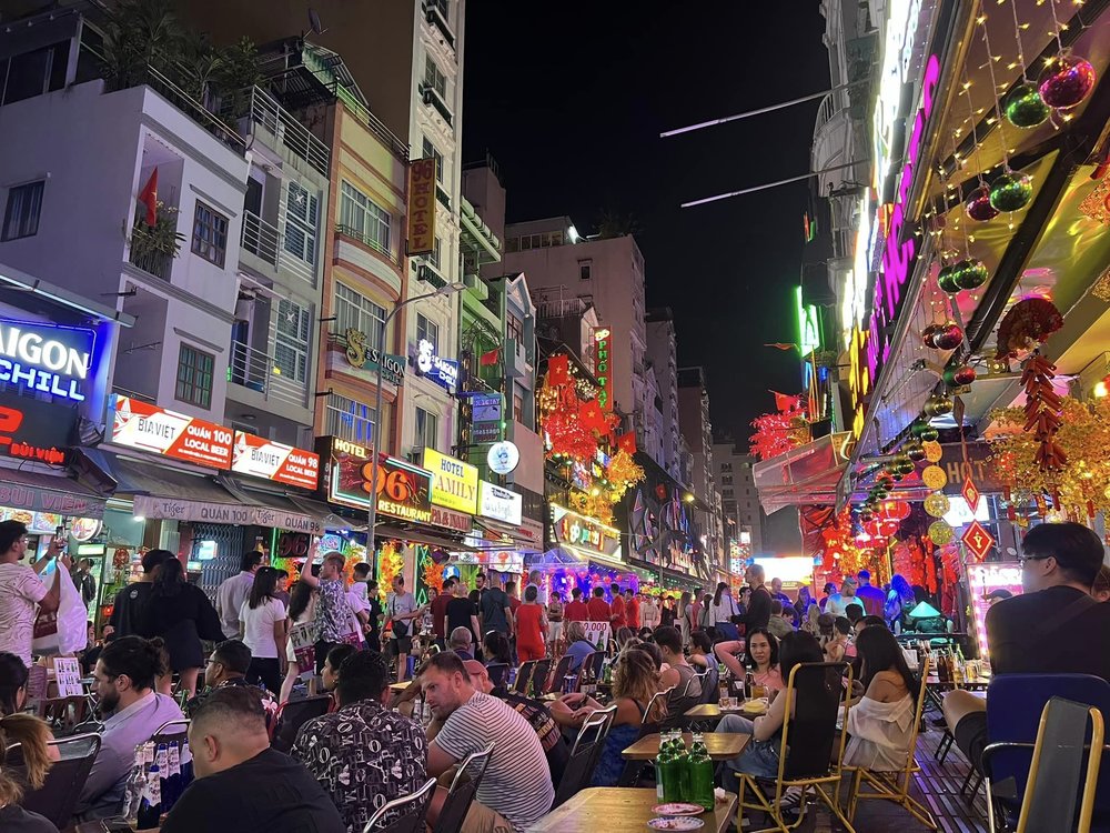 Lively Bui Vien Street in Ho Chi Minh City featuring open-air bars and nighttime crowds
