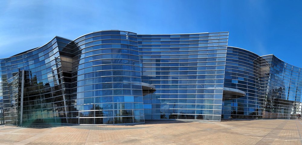 Exterior of a modern art museum building with curved glass architecture