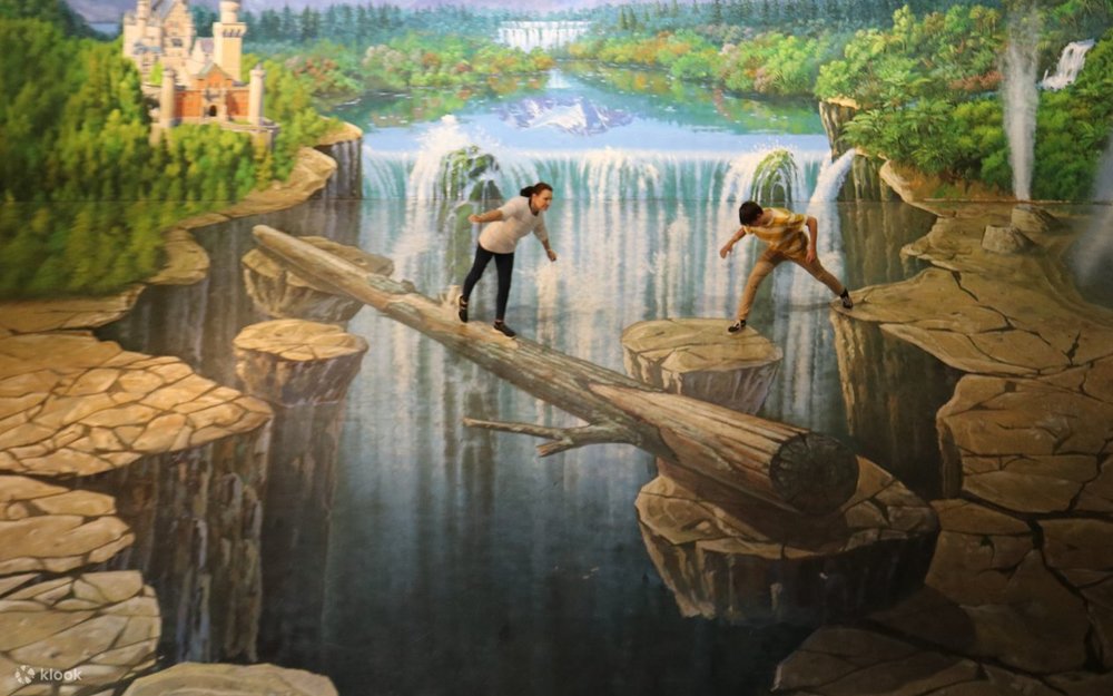 People interacting with illusion-style artwork at a 3D trick art gallery