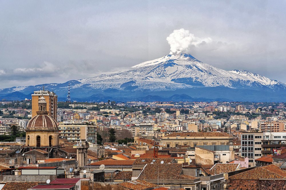City view of Catania with Mount Etna rising behind rooftops