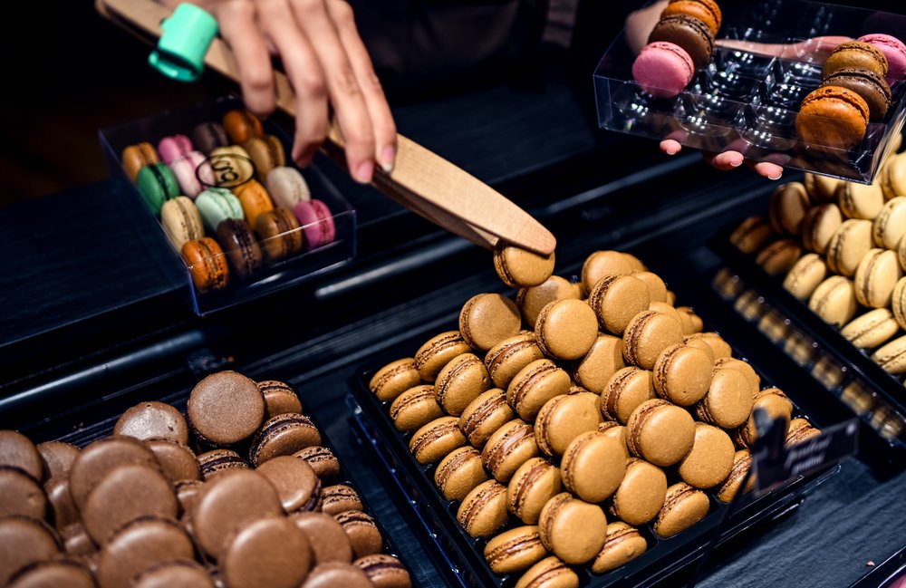 Assorted French macarons displayed in a Paris dessert shop