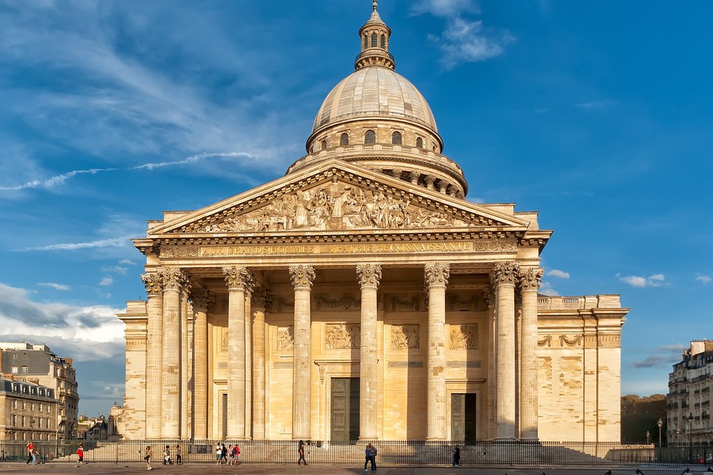 A lively street scene in Paris’ Latin Quarter with cafés and colorful buildings