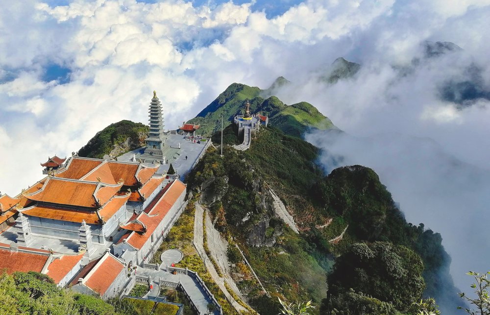 View from the top of Fansipan peak in Lao Cai, Vietnam, surrounded by misty mountains
