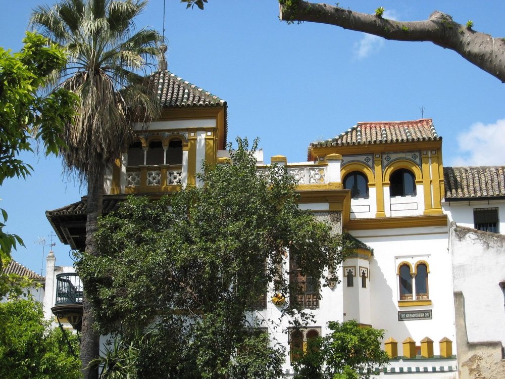 Barrio Santa Cruz Seville, featuring colorful buildings and lush trees