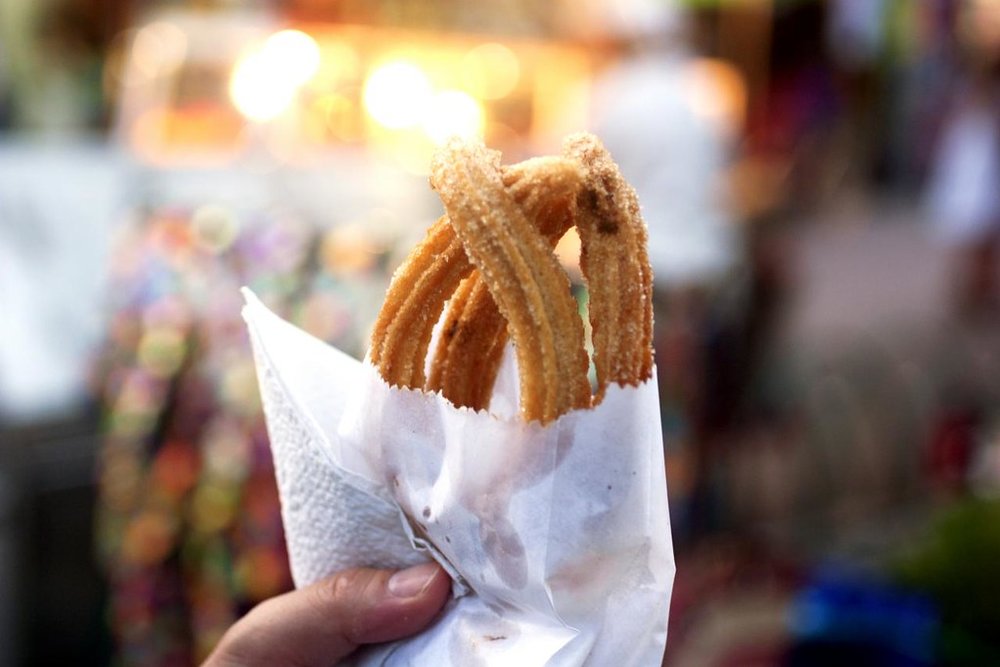 Fresh churros in paper cone street snack
