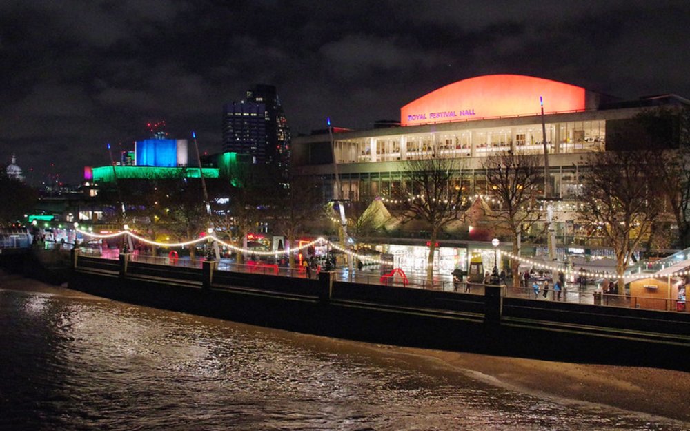 Southbank Centre illuminated at night near the London Eye