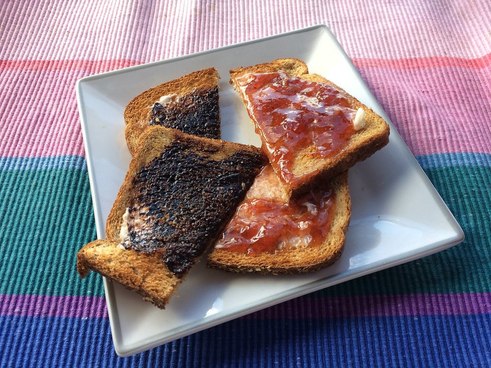 Slices of toast spread with Vegemite and jam on a plate