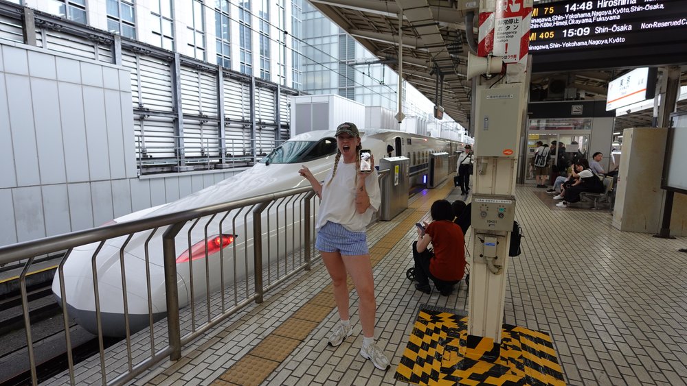 Woman on a Shinkansen platform waiting for the train to arrive
