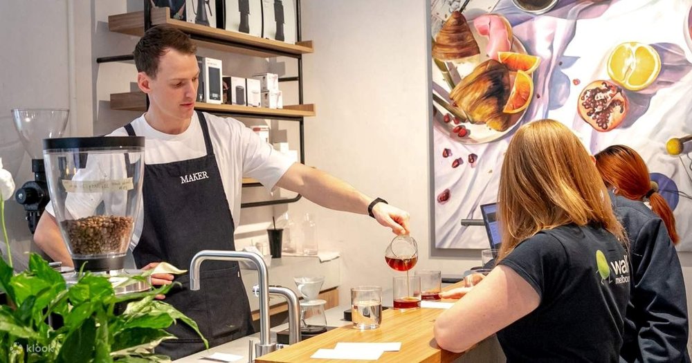 A barista pouring coffee into cups