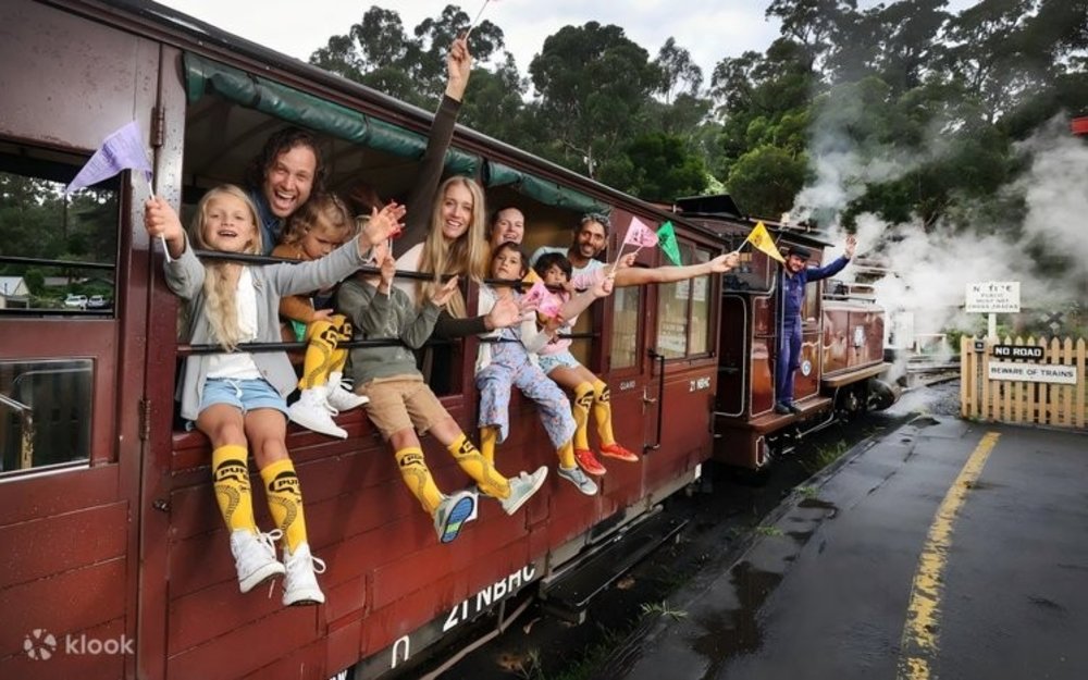 Passengers of the Puffing Billy Steam Train waving