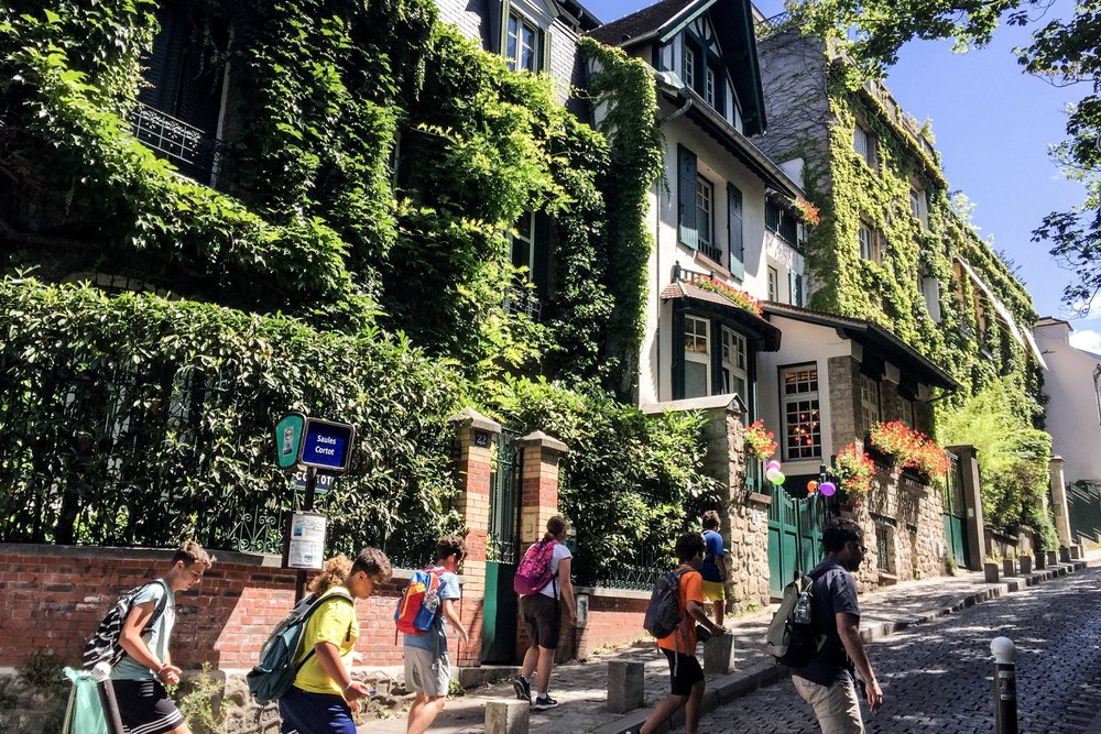 Montmartre cobblestone street with ivy-covered houses