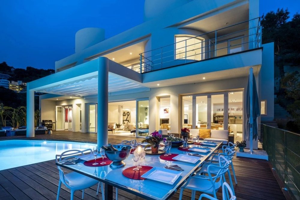 Luxury Villa Infinity in Ibiza with private pool and outdoor dining area at night