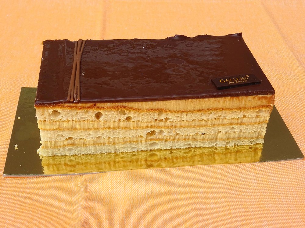 Classic Opera cake showing almond sponge and chocolate layers
