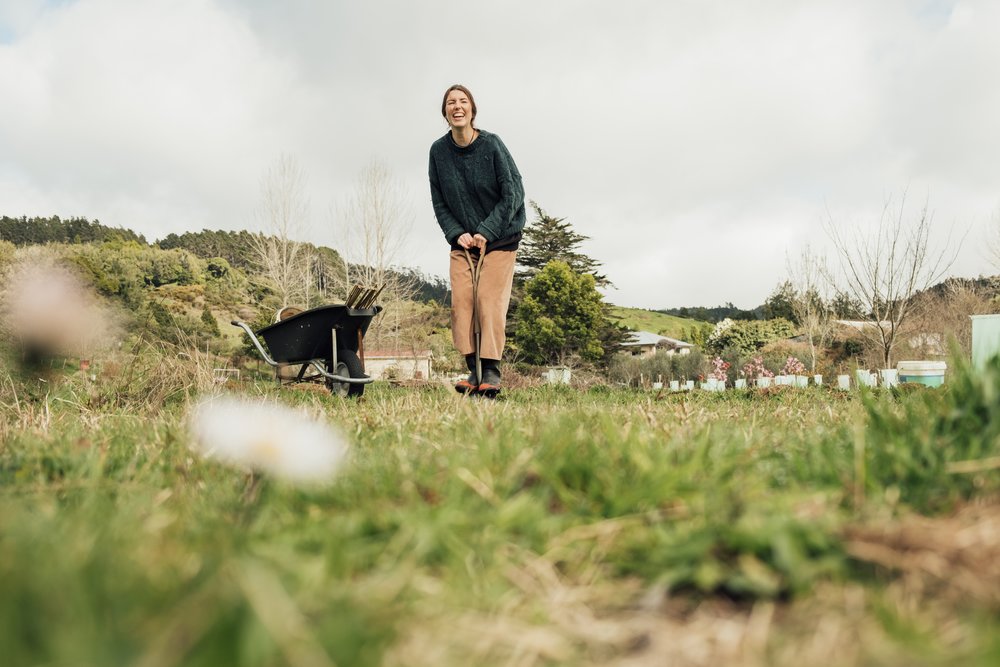 Woman gardening in the countryside during mild autumn in New Zealand weather