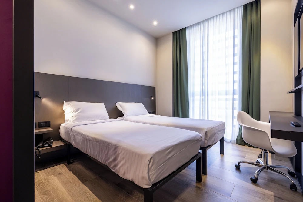 Bright twin room with desk and window at Hotel degli Arcimboldi Milan