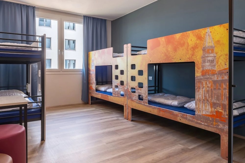 Shared dorm room with bunk beds at a&o Hostel Venezia Mestre near train station