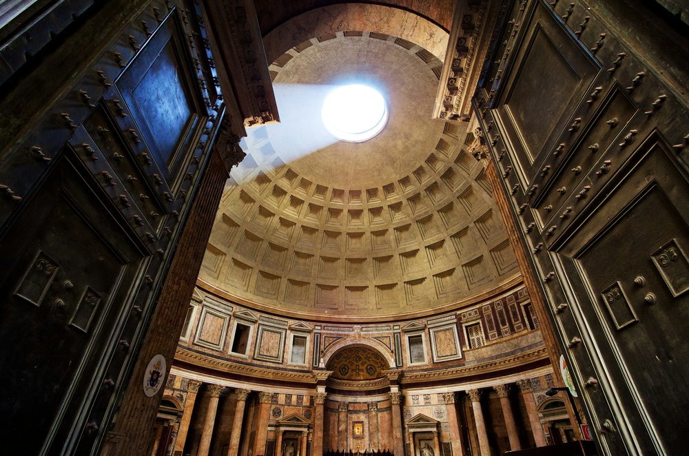 Interior of the Pantheon in Rome with sunlight streaming through the oculus | Photo Credit: Evan Qu on Unsplash
