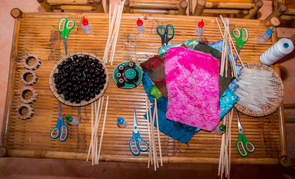 Lantern-making materials and tools arranged on a workshop table in Hoi An